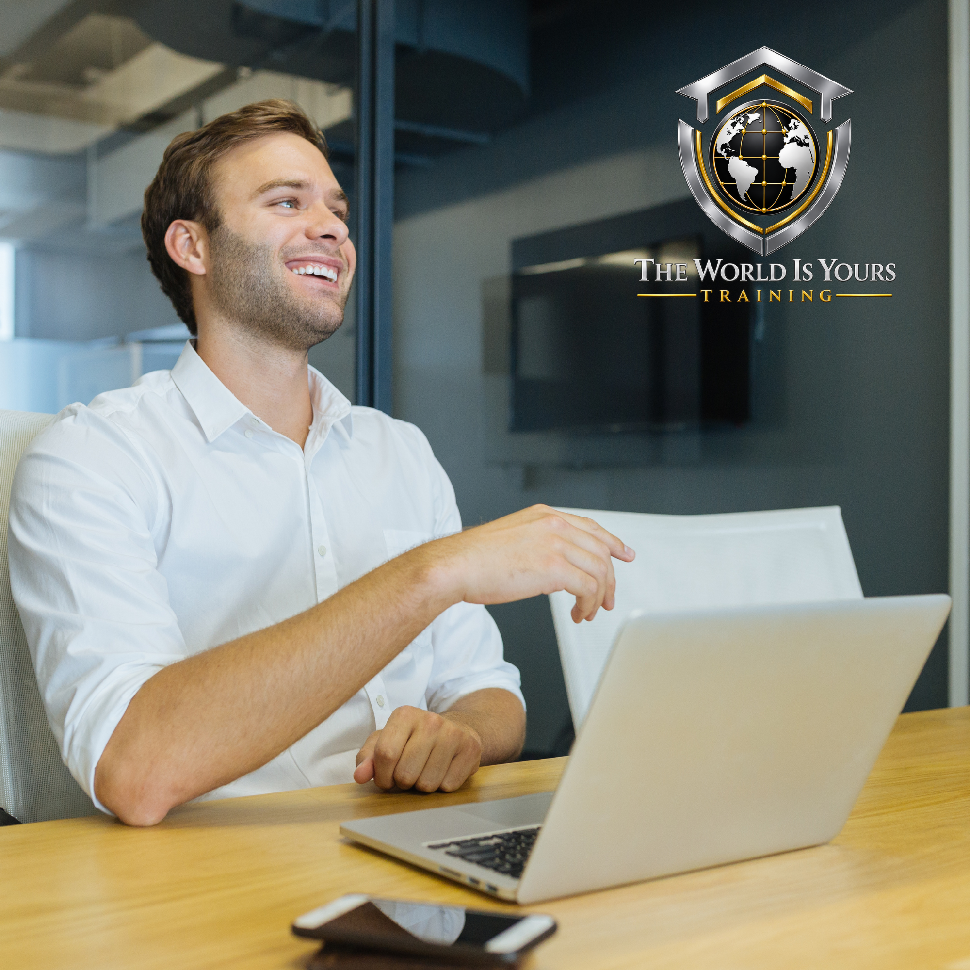 A professional at a laptop beside The World Is Yours Training branding